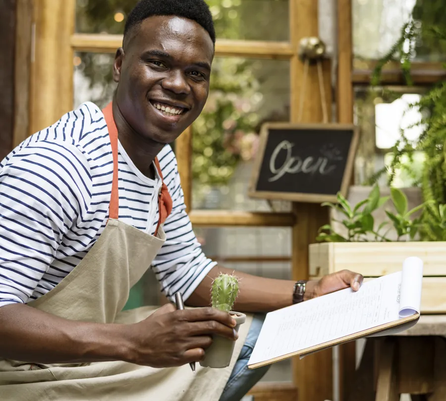 Adult man checking plants outside flower shop