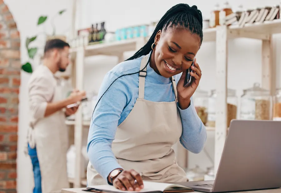 Black woman cashier phone call with networking inventory che