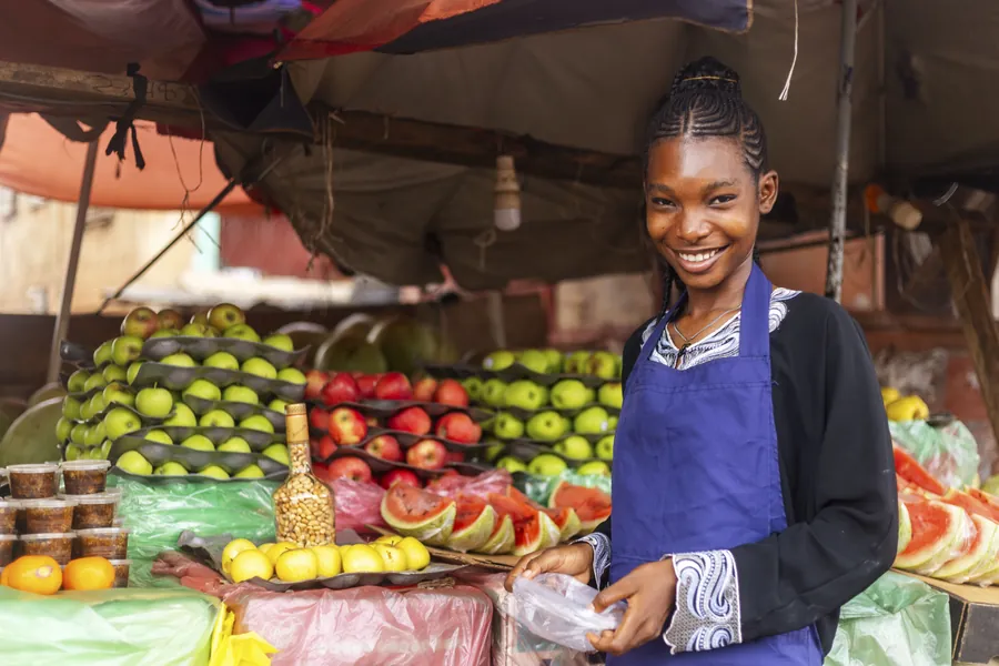 Young african female fruit seller at her stand